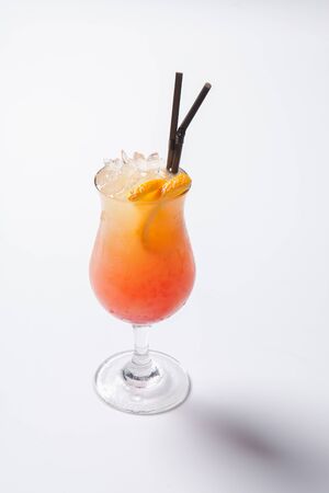 Tequila sunrise cocktail with ice. Isolated on white backgroundの写真素材