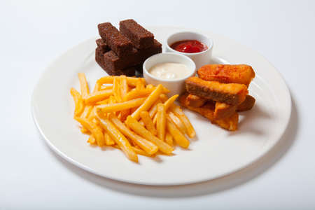 fish sticks with french fries on a white plate. White backgroundの写真素材