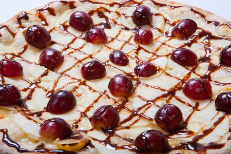 sweet apple pizza with sliced grape on white background. Close upの写真素材