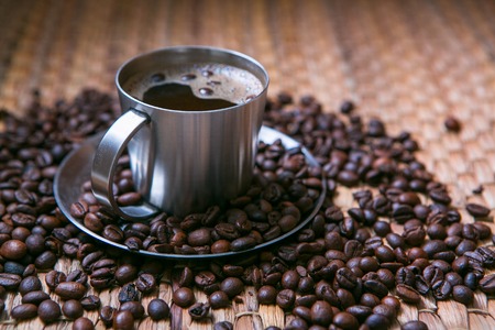 coffee cup and coffee beans on wooden table.の写真素材