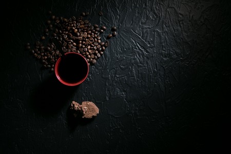 coffee cup and coffee beans on wooden table with cookies.の写真素材