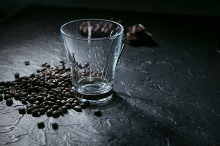 empty coffee cup and coffee beans on black background.の写真素材
