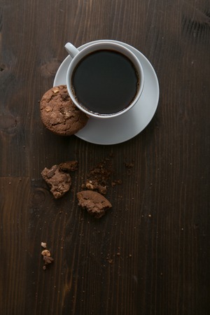 coffee cup and cookies on wooden table.の写真素材