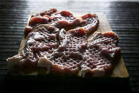 Raw meat on dark background. Raw pork steak.の写真素材