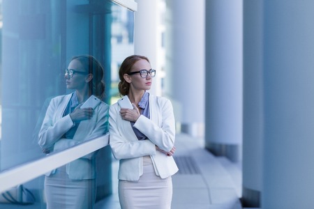 Portrait of business woman talking on smartphone outdoor