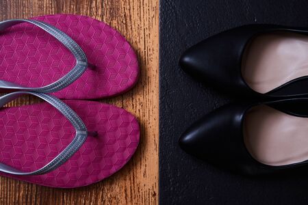 Work life balance choice concept: colored sandals or flip-flops and strict black office shoesの写真素材