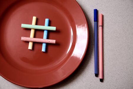Food blogging, blog and blogger or social media concept: symbol hashtag on the red plate. Flat lay.