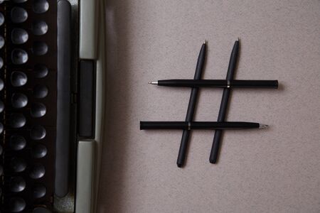 Literature blogging, blog and blogger or social media concept: symbol hashtag and a retro typewriter...