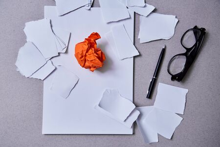 Inspiration, insight or good idea concept: a crumpled piece of orange paperの写真素材