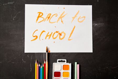 Back to school or student and education concept. Top view. Crayons , paints and watercolors.