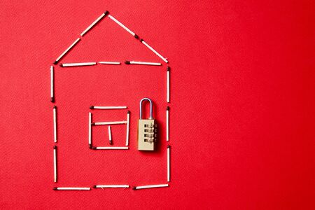 Fire safety, or security and protection concept. A fire extinguisher, the figure of the house and...