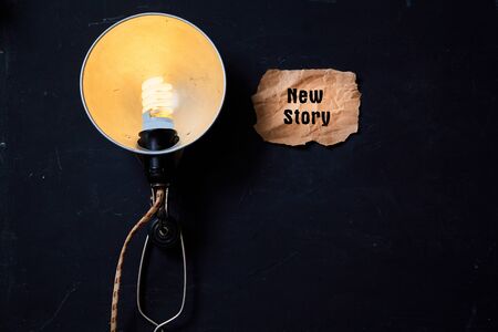 Creative, bright idea and innovation or inspiration concept. Electric lamp and a piece of paper