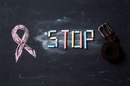 Concept for fear, domestic violence and family or child abuse. Stop sign and beltの写真素材