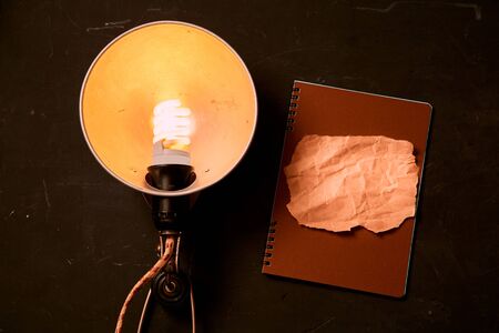 Creative, bright idea and innovation or inspiration concept. Electric lamp and a piece of paperの写真素材