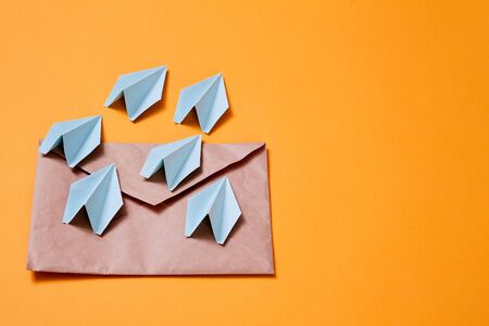 Concept for sending e-mails and e-commerce business. Email marketing. Paper planes flying out of the...