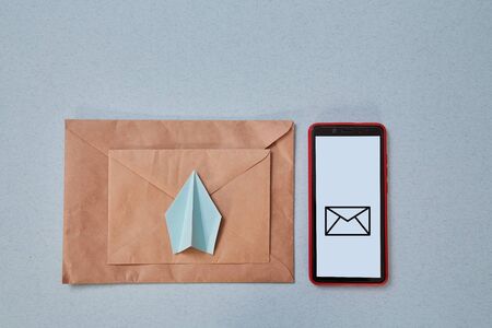 Email marketing and message online, online chat concept: Paper plane , envelope and smartphoneの写真素材