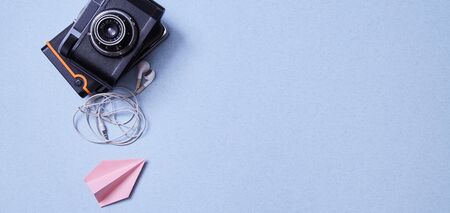 Freelance work, adventure and blogging concept. Vintage camera, hard drives and airplane