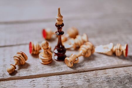 Chess game, leadership and business competition. Battle and strategy. The chess king standing among the fallen pieces.の写真素材