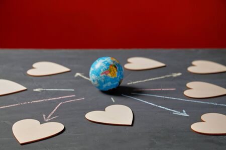 Global communication and networking. Internet or online dating, sharing and social media. Globe and figures of heartsの写真素材