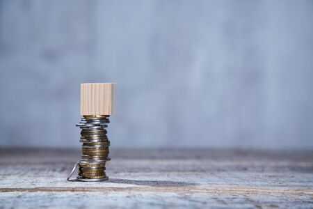 Real estate purchase or investment in immovable property. Housing market. Coins with wooden bricks...