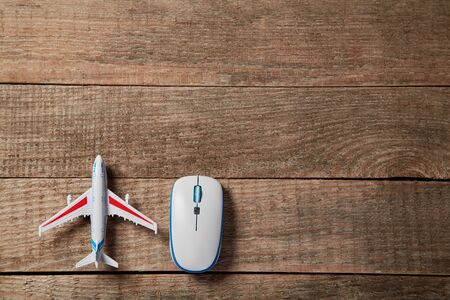 Remote booking tickets. Travelling and online reservation. Book online. Computer mouse and plane. Airplane departure.の写真素材