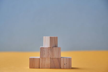 Pyramid of wooden blocks mockup with empty place for text. Business strategy. Career ladder. Growth...