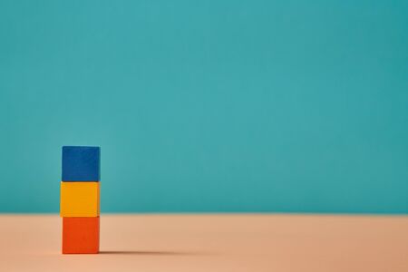 Stack of cololorful cubes mockup, empty copy space. Pile of blue, yellow and orange blocks with...