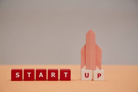 Business innovation. Beginning project. Creative idea. Rocket symbol, wooden cubes. Start up...