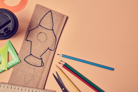 Beginning new business start-up mockup. Start project. New goal, idea. Top view of rocket symbol on cardboard paperの写真素材