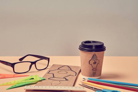 Business start-up. Launch of project. Creature new idea. Rocket symbol on paper glass and cardboard...