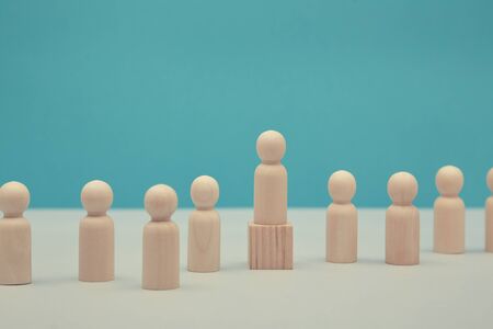 Sense of purpose, goal achievement mockup. Human resources. Career growth, HR.Wooden leader figure on cube. Copy spaceの写真素材