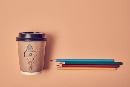 New beginnings. Learning and skills. Self development. Beginning start-up. Paper cup with rocket launch, copy spaceの写真素材
