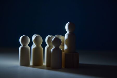 Shadow economy mockup. Black market. Undeclared work. Corruption. Wooden figure on cube, people miniature, copy spaceの写真素材