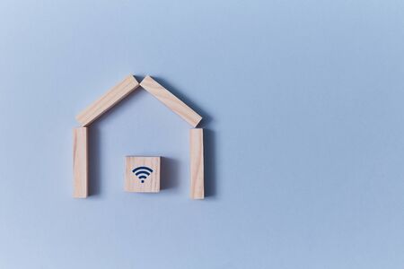Online offer of property sale, rent. Remote reservation. Booking house on-line. Wooden home, cube inside with wifi signの写真素材