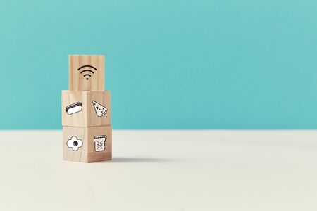 Home delivery service. Food ordering online. Express delivery. Wooden cubes, meals signs. Block on...