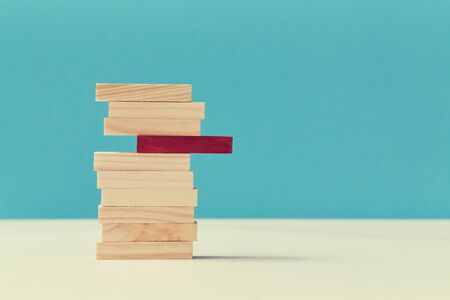 Pile of wooden blocks with one red plank. Uniqueness and originality. Think outside box. Not like everyone. Copy space.の写真素材