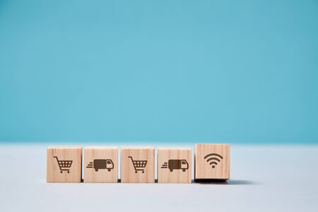 E-store, delivery service online. On-line supermarket and purchasing goods. Wooden cubes, trolley,...