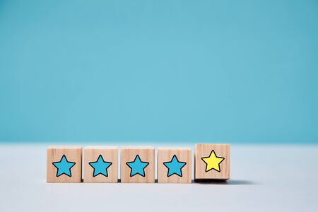 Rate service quality. Customer experience. Total satisfaction. Wooden bricks with five stars....