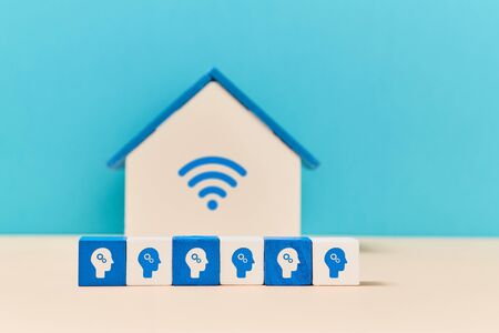 Freelance. Work from home. Online distance working. Stay home. Wooden house with wifi sign, cubes with person symbolsの写真素材