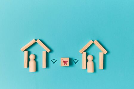 Online shopping. Delivery service. E-store. Wooden cube with trolley, wifi signs between houses with...