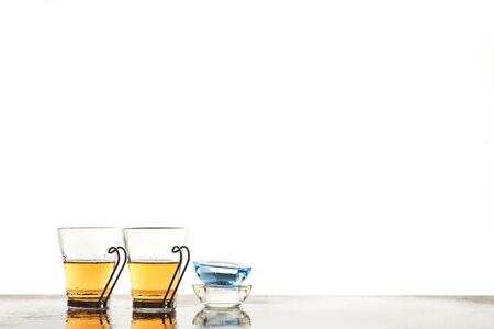 Glass cups with herbal tea. Candleholder. Tea ceremony and spa day. Wellness concept. Copy space....