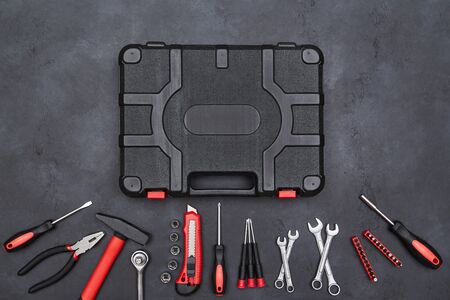 Repair instruments around black toolbox. Craftsmans tools. Renovation and building concept. Dark...