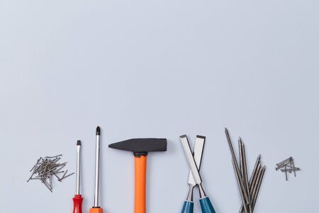 Set of repairmans instrument. Gear and construction site concept. Labor day. Isolated on blue background. Copy spaceの写真素材