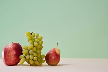 Mellow summer bunch of grape red apple and pear. Healthy lifestyle concept. Copy space. Isolated on...