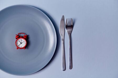 Served table. Reception of guests. Time to eat. Celebration concept. Top view of red alarm in plate...
