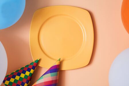 Celebration concept. Happy Birthday. Top view of plate, hat, funny glasses and balloons. Children...