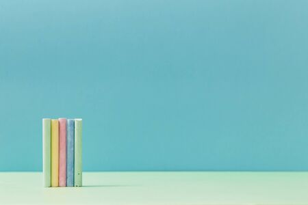 Welcome back to school. Time to study concept. School supplies. Colored crayons set on blue background, copy spaceの写真素材