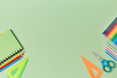 Back to school. Start of schooling. New academic year. Stationery set on green background. School...