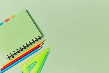 Stationery set on green background. Back to school. Start of schooling. New academic year. School...