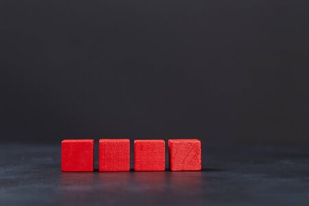 Red wooden cubes mockup for inscription design. Blocks in line template on dark background, copy space. Black fridayの写真素材